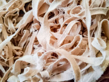 Macro shot of a pile of beige paper shavingsの写真素材