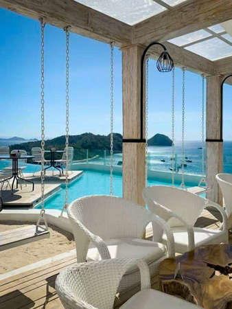 View of the pool from the terrace of a luxury villaの写真素材