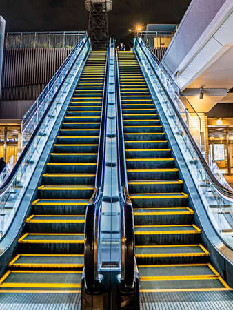 Escalator in a shopping mall at night, London, UKの写真素材