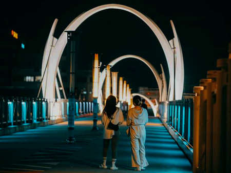 Couple in love walking on the bridge at night. Love concept.の写真素材