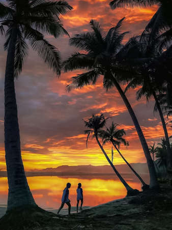 couple on a tropical beach at sunset,3d render illustrationの写真素材