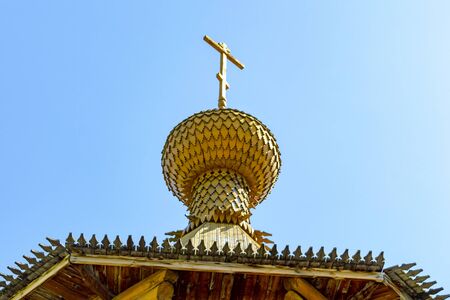 Dome with a cross of a wooden Christian church in the sun. View from below.の写真素材