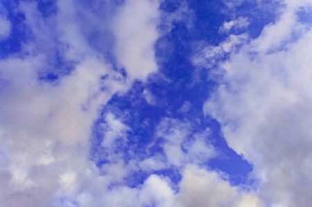 On a blue sky and white clouds A storm in the fall in Siberia before the first snow.