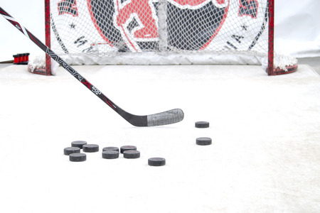 The game of hockey. Putter, a lot of pucks and gates. Front view. Concept. Surgut, Russia - 12 June, 2019のeditorial素材