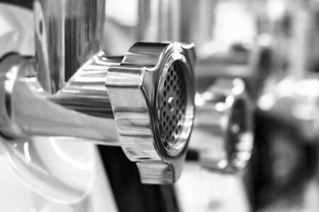 Metal shiny tube of an electric meat grinder. Side view. Black and white shot.の写真素材