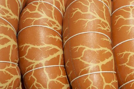 Several boiled sausage in beautiful package. Top view. Close up.