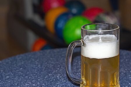 Mug of beer on the table in the bowling centerの写真素材