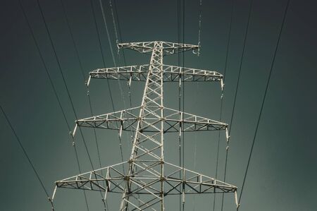 Support of high voltage line in winter. View from below. Gradient sky. Siberia.