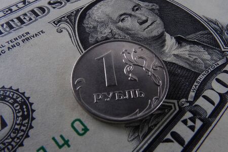 One ruble coin on a paper dollar. National currency devaluationの写真素材