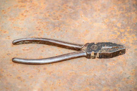 Rusty pliers on rust background. Subject shot. Front and top view.の写真素材