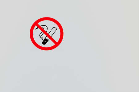 Icon not to smoke on gray wall. View from the front. Copy space.