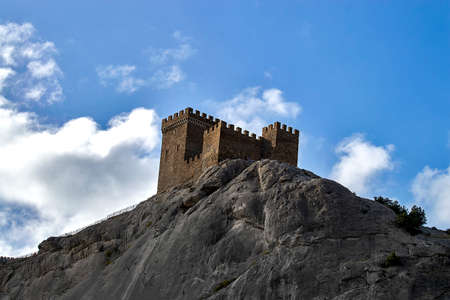 The tower of the Genoese fortress. View from below against the cloudy sky in the afternoon. Sudak, Crimea - 10 October 2020.のeditorial素材