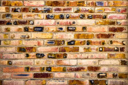 An old vintage brick wall background. View from the front. UNUSUAL SURFACE.