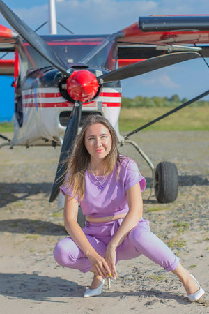 Woman sits in background of plane. Super good warm autumn day.