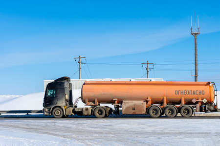 The truck with the semi-trailer tank. Inscriptions on russian language - flammable. Surgut, Russia - 10 March, 2021.のeditorial素材