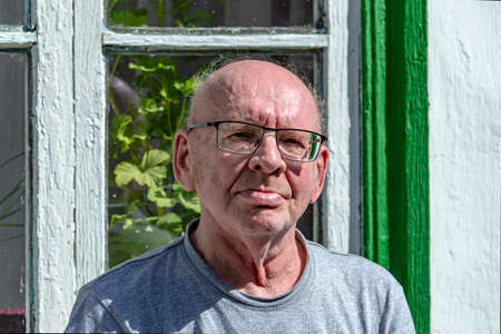 Old grandfather with glasses is bald.の写真素材