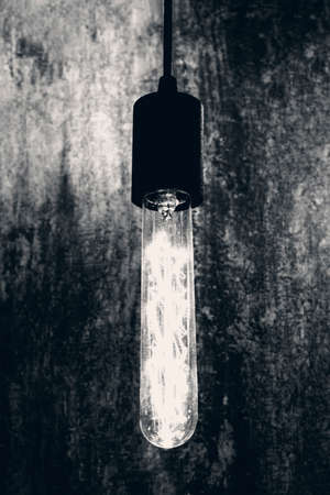 Light bulb in retro style. Front view, indoors vertical shot.