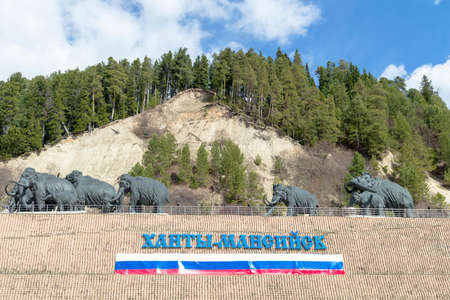 Statue of mammoth and inscription and flag on the Russian Hunty-Mansiysk. Hunty-Mansiysk city,...