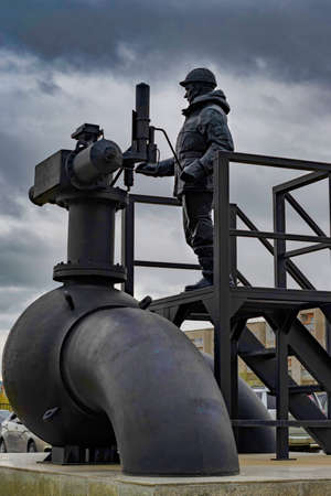 Monument to oilman. Day, vertical shot Front view. Surgut, Russia - 17, May 2021.