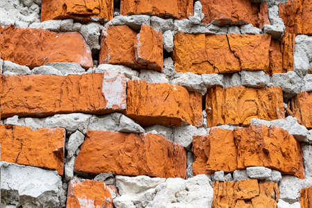 Old cracked red brick wall unique texture background. Copy space.