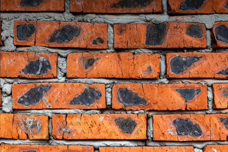 Old cracked red brick wall unique texture background. Copy space.