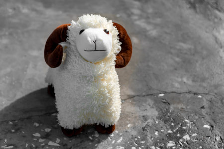 Plush sheep on a concrete base in summer.の写真素材