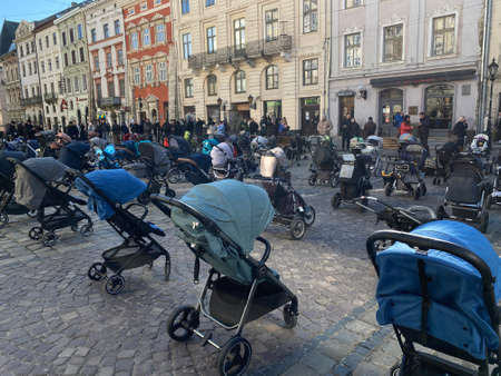 March 18, 2022 - Lviv, Ukraine: Installation of empty baby carriages on the main square of the city in memory of the children who died in the war of Russia against Ukraine.のeditorial素材