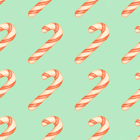Red and white striped candy canes on a blue background. Christmas seamless pattern with candy canesの写真素材