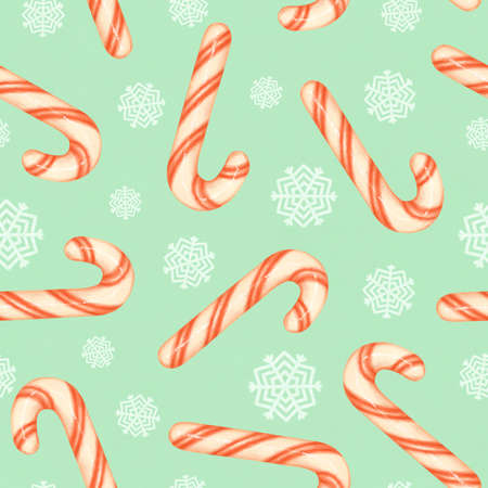 Red and white striped candy canes and white snowflakes on a blue background. Christmas seamless pattern with candy canes and snowflakesの写真素材