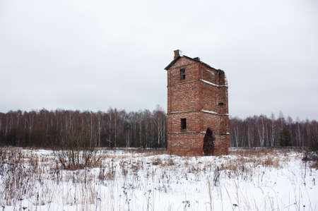 Old abandoned brick oast house in a fieldの写真素材
