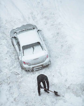 The in driver cleans the road from snow in order to drive the carの写真素材