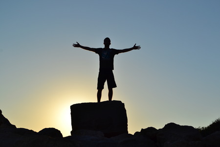 Silhouette of man feeling of freedomの写真素材