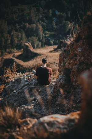 Man sitting on rockの写真素材