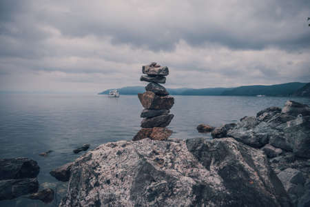 A tower of stones on the background of lake baikalの写真素材