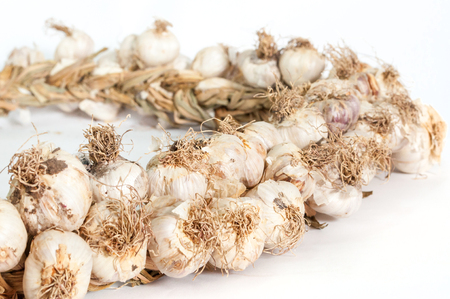 Garlic woven into a wreath for better storageの写真素材