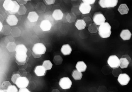 Bright bokeh hexagon shape on black background.