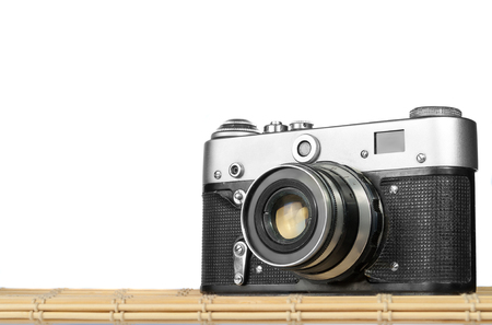 Retro camera on a bamboo table .の写真素材