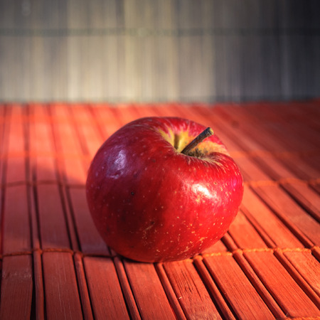 Red apples on weathered wooden background .の写真素材