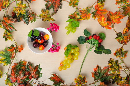 Different autumn fruits among the leaves, top view .の写真素材