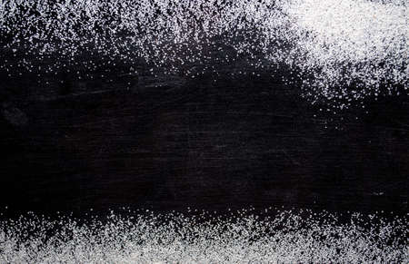 White sand on a black background, texture.