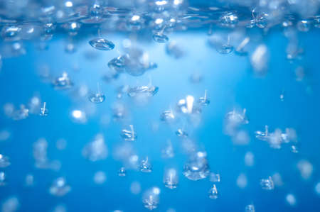 air bubbles in the water isolated on blue background.