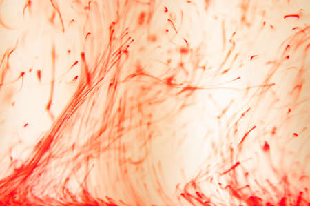 Red paint dissolves in liquid, process.