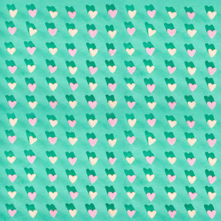Candy of different colors on a turquoise background, a heart texture on Valentines Day
