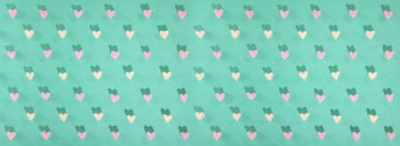 Candy of different colors on a turquoise background, a heart texture on Valentines Dayの写真素材