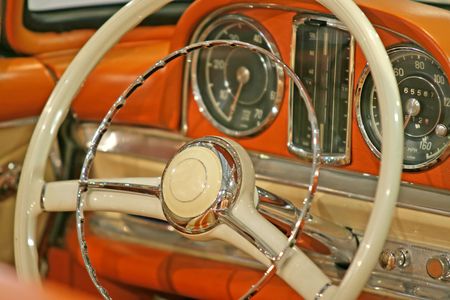 Close up of the steering wheel of a classic old car