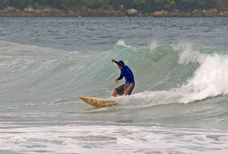 Surfer performs a tight turn on a wave at Phuket in Thailand