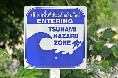A tsunami warning sign located near a beach in Phuket, Thailandの写真素材