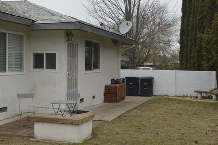 Outdoor furniture and table in a backyard of a house in winterの写真素材