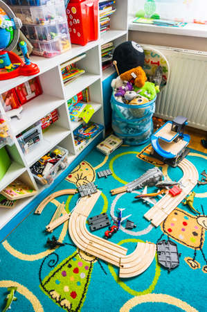 Poznan, Poland - May 17, 2020: Child room with furniture and wooden train track on a carpet floor. Vertical high angle view.のeditorial素材