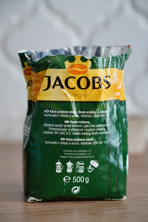 Poznan, Poland - July 20, 2023: Opened package of Jacobs Kroenung coffee on a table.のeditorial素材